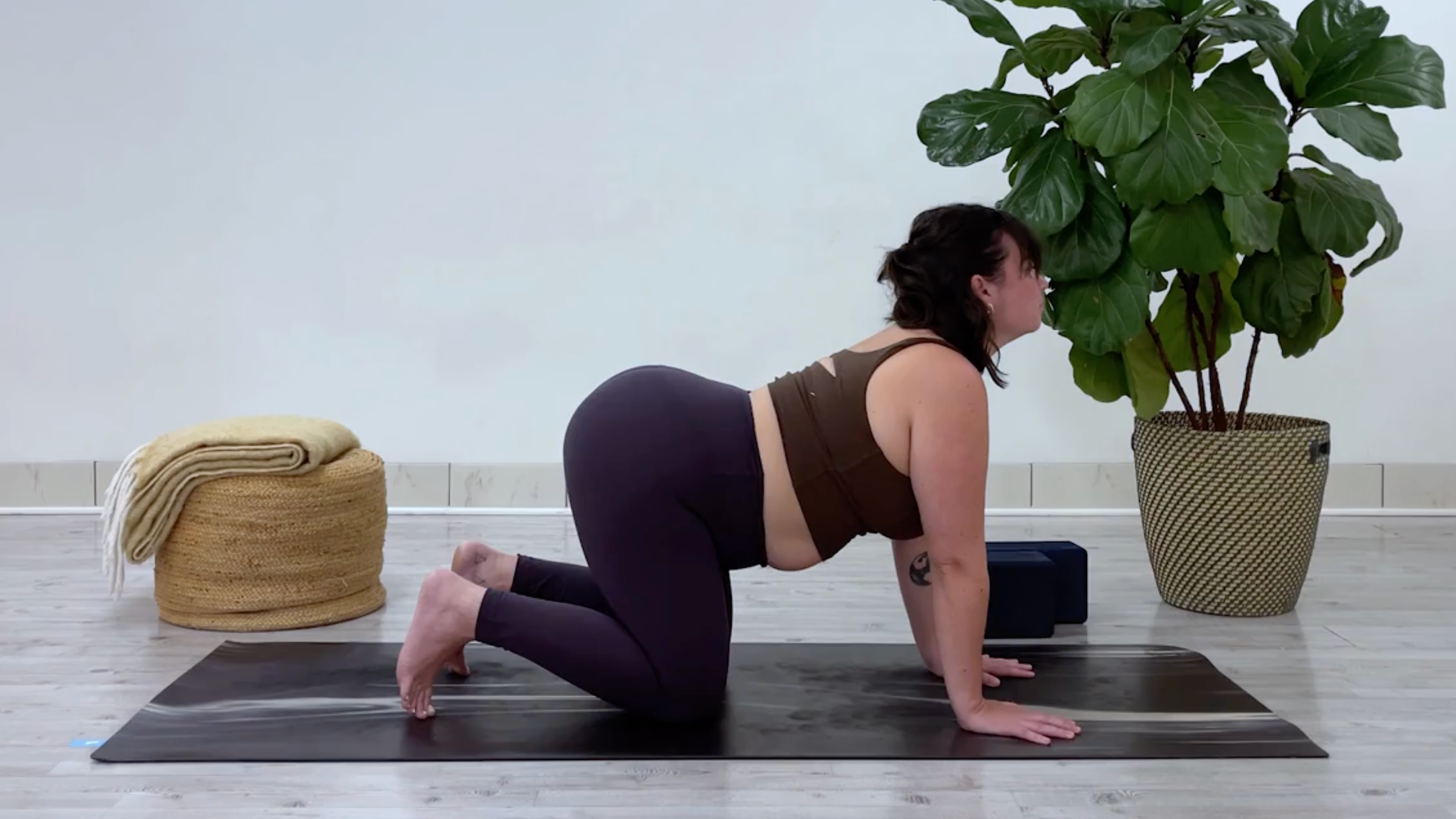 Yoga teacher Taylor Lorenz in Cow Pose, part of her yin yoga for stress routine